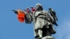 SPAIN -- Activists from the Spanish Proactiva Open Arms charity place a life jacket on the Christopher Columbus statue after the Open Arms rescue boat arrived at a port in Barcelona, Spain, carrying migrants rescued off Libya, July 4, 2018