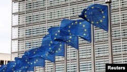 European Union flags flutter outside the EU Commission headquarters in Brussels